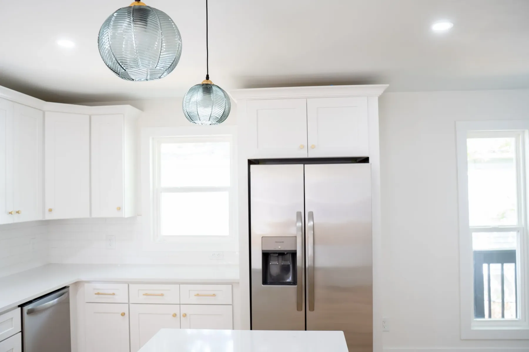 Kitchen with stainless refrigerator