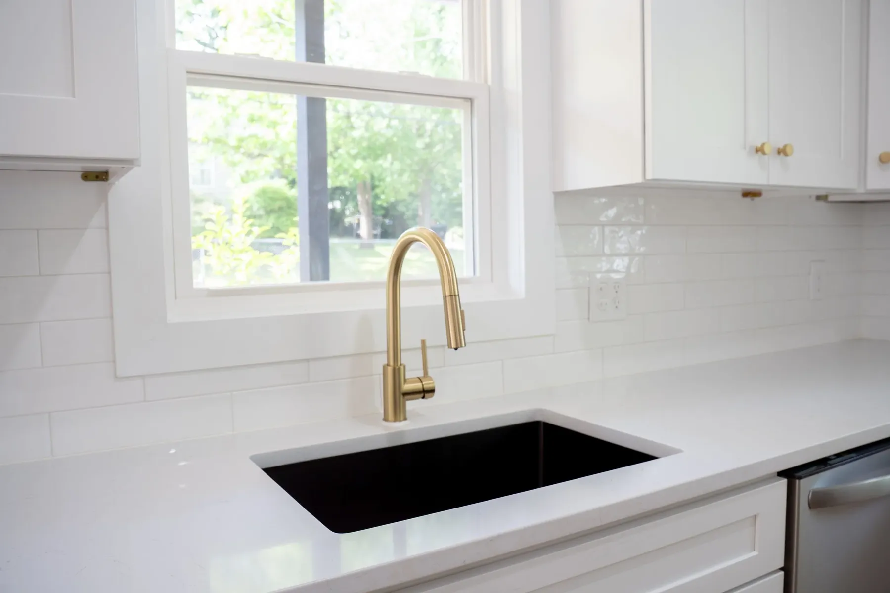 Undermount black sink with brass faucet