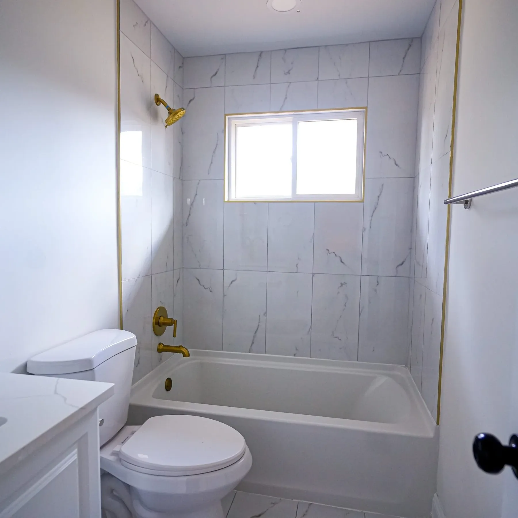 Full bath with tiled tub surround