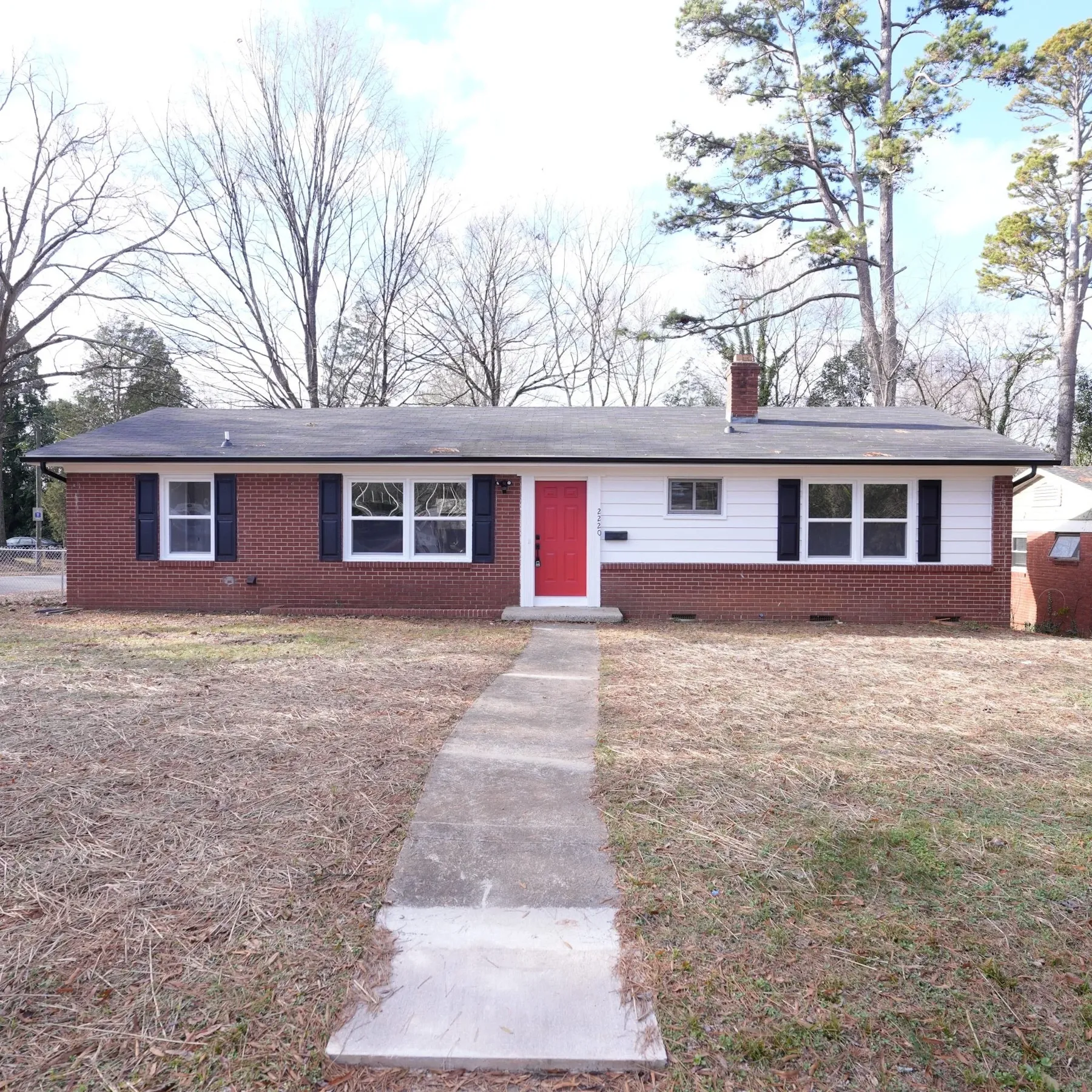 Brick ranch house with red front door