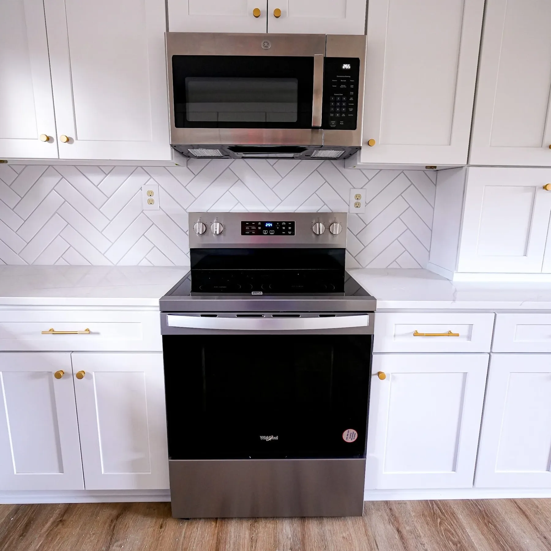 Range wall with herringbone tile backsplash